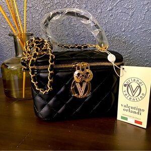 Quilted vanity box bag. Top handle, braided shoulder strap included.